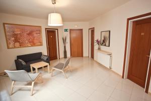 a living room with a couch and chairs and a table at Hotel Beri - Can Llançà in Llança +2 photos