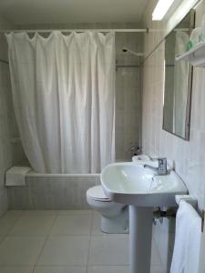 a bathroom with a sink and a toilet and a shower at Hotel Beri - Can Llançà in Llança