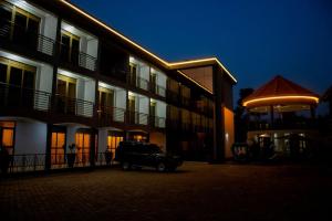 a car parked in front of a building at night at Spark Africa Hotel in Jinja