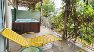 a yellow bench on a porch with a hot tub at Jacob Nea in Shave Ẕiyyon +95 photos