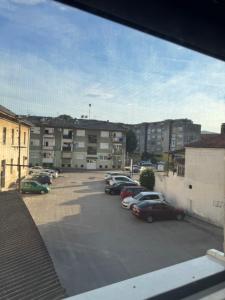 a parking lot with cars parked in front of buildings at StanČapljina in Čapljina