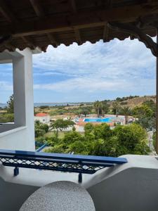 a view of a pool from the balcony of a house at Orama Hotel in Sígrion