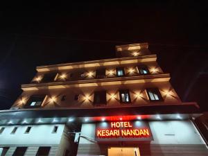 a building with a hotel krishnan mandalam sign at night at Hotel Shree Kesari Nandan in Dwarka