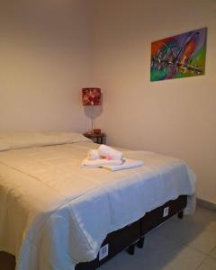 a room with two beds with towels on top of it at Temporario La Marcela in Resistencia