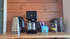 a coffeemaker sitting on a table with a coffee maker at Saunatupa Kajaani in Kajaani