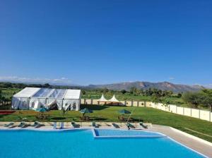 a resort with a large swimming pool and a tent at The Africana Hotel in Isiolo