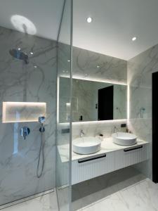 a bathroom with two sinks and a mirror at Jõelähtme Golf Villa with Sauna and Terrace Grill - near EGCC Golf Course in Manniva +15 photos