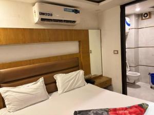 a bedroom with a bed and a bathroom with a toilet at Royal with - Group Name Hotel Double R- comfort stay in Main Bazar New Delhi in New Delhi +17 photos
