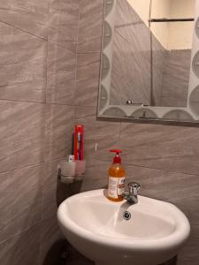 a bathroom with a white sink and a mirror at Makao Home in Arusha +27 photos