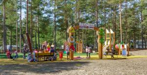 a playground in a park with people playing on it at Yyteri Camping Cottages in Yyteri