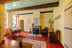 a living room with a fireplace and a table at Het Schultehuis in Anloo