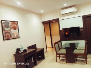 a room with a table and a chair and a desk at Hotel Mumbai House Thane in Thane +39 photos