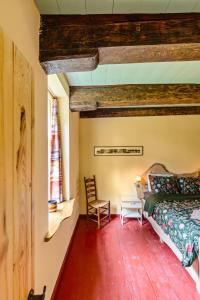 a bedroom with a bed and a chair in a room at Het Schultehuis in Anloo