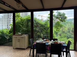 a dining room with a table with chairs and a kitchen at Green Garden Hotel in Makhinjauri +62 photos