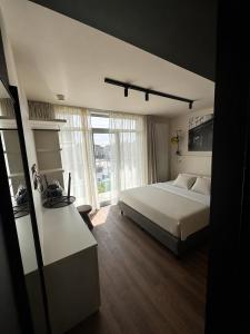 a bedroom with a bed and a large window at Roxi Roosevelt in Antwerp +8 photos