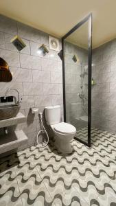 a bathroom with a toilet and a glass shower at The Grembeng in Undisan +16 photos