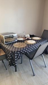 a table with a polka dot table cloth with plates on it at Sharks View in Port Shepstone