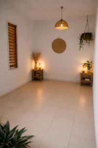 an empty room with two tables and a light at Papaya Camping in Les Abymes
