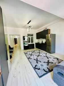 a large kitchen with a large rug on the floor at Квартира in Koshkolʼ