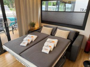 a bed in a room with three pillows on it at Hausboot mit Sauna - TraumZeitBoot Heidi - exklusiver Festlieger in perfekter Lage am Scharmützelsee Bad Saarow in Bad Saarow