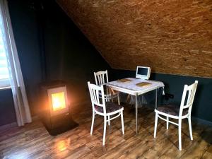 a table with two chairs and a laptop computer on it at Apartament Babina Loft in Żarkie Małe