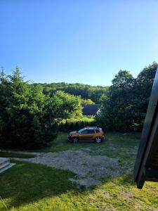 a car parked in a yard next to trees at Apartament Babina Loft in Żarkie Małe
