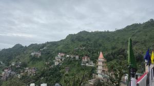 a view of a mountain with buildings on it at Sagar plaza in Mussoorie +8 photos