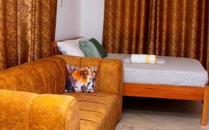 a living room with a couch and a bed at Dynasty homes in Bamburi