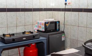 a microwave sitting on top of a stove in a kitchen at Dynasty homes in Bamburi