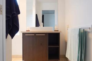 a bathroom with a sink and a mirror at Waterfront Primrose Retreat in Primrose Sands +68 photos