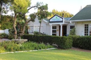 a white house with a sign on it at Somer Place B&B in Somerset West +49 photos