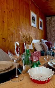 a table with wine glasses and a bowl on it at Otuleni Kaszubami in Kiełpino