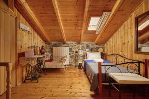 a bedroom with a bed in a room with wooden walls at Villa Galateia in Dhafnés