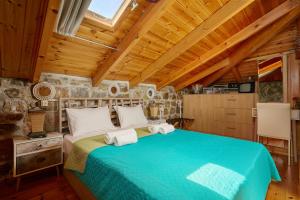 a bedroom with a bed and a wooden ceiling at Villa Galateia in Dhafnés +24 photos