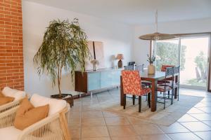 a dining room with a table and chairs at Casa do Suave Mar in Esposende