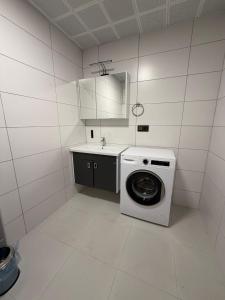 a kitchen with a washing machine and a sink at Mimoza Apart in Trabzon +186 photos