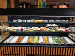a display case with many different types of food at FlexInn Hotel Gelsenkirchen in Gelsenkirchen