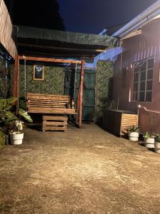 a patio with a wooden bench next to a building at Makao Home in Arusha