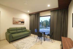 a living room with a couch and a table at Mihas Hotels and Resorts in Malappuram