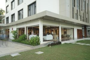 a building with glass doors and tables in a courtyard at Mihas Hotels and Resorts in Malappuram
