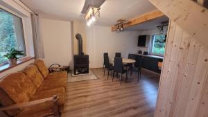 a living room with a couch and a wood stove at Niebo do wynajęcia in Kłodzko