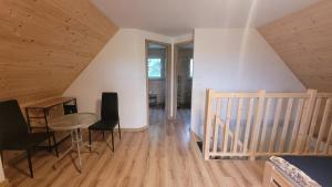 a room with a table and chairs in a attic at Niebo do wynajęcia in Kłodzko