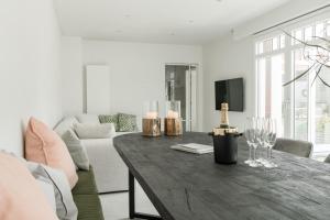 a living room with a wooden table with wine glasses at Oud Peer in Peer +38 photos