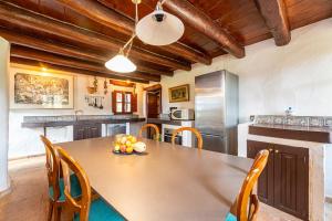 a kitchen with a table with a bowl of fruit on it at Finca Son Xona in Capdepera