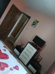 a bedroom with a bed and a mirror at Teo&Alex in Năvodari