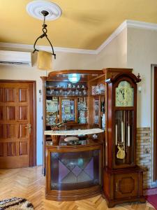 a room with a grandfather clock in a room at Shkodra Central in Shkodër +4 photos