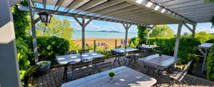 a patio with tables and chairs under a pergola at Villa17 in Badacsonytomaj