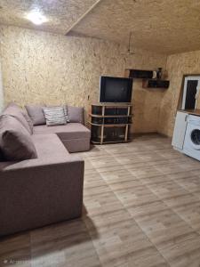 a living room with a couch and a flat screen tv at Modern Apartment Near Sevan Lake in Sevan