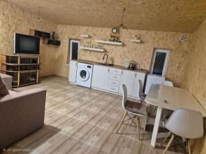 a kitchen and living room with a table and chairs at Modern Apartment Near Sevan Lake in Sevan