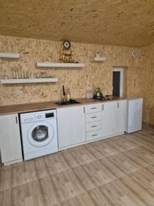 a kitchen with a washing machine and a sink at Modern Apartment Near Sevan Lake in Sevan +3 photos